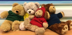 Four teddy bears in jumpers