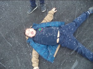 boy catching snowflakes