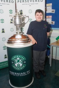 Boy standing next to Scottish Cup
